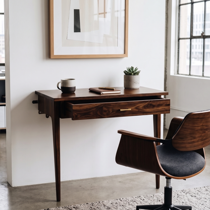 Natural Wooden desk with chair in a room with a window and framed picture.