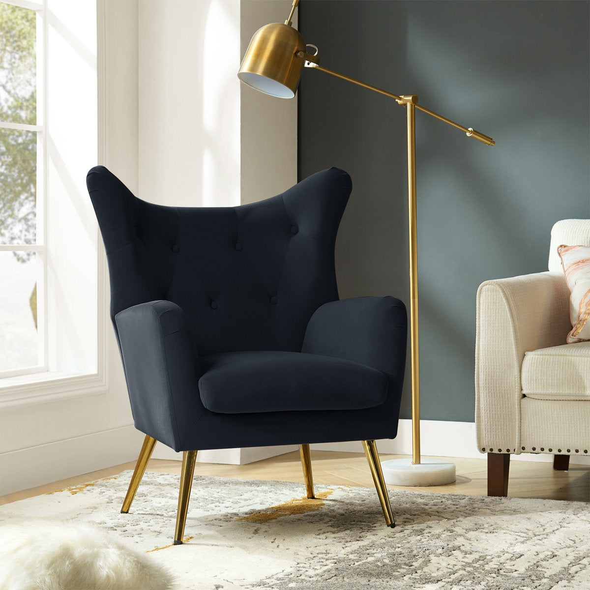 Navy armchair with gold legs in a modern living room setting