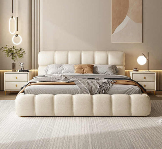 Neatly made bed with decorative pillows in a modern bedroom setting.