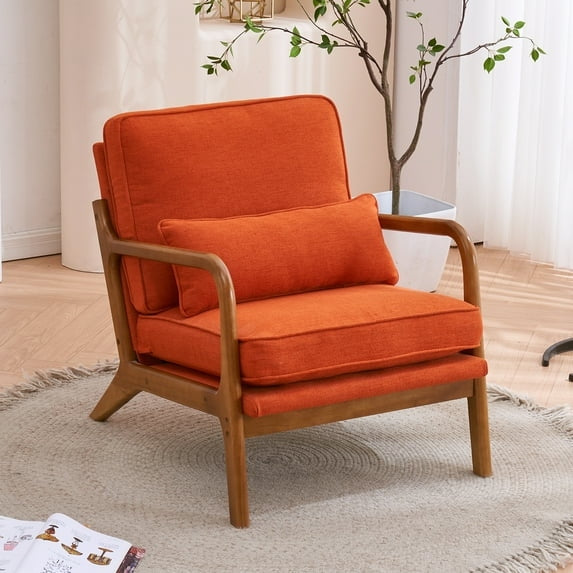 Orange armchair with wooden frame in a room with a plant and rug.