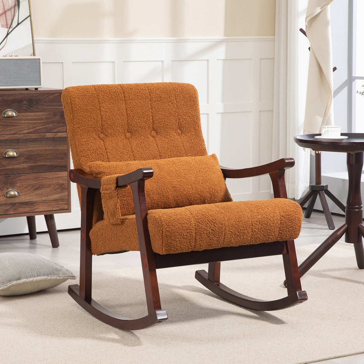 Orange rocking chair in a room with wooden furniture and a window.