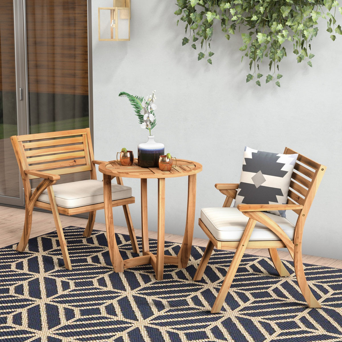 Outdoor patio set with wooden chairs and table on a patterned rug.