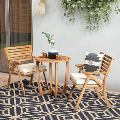 Outdoor patio set with wooden chairs and table on a patterned rug.