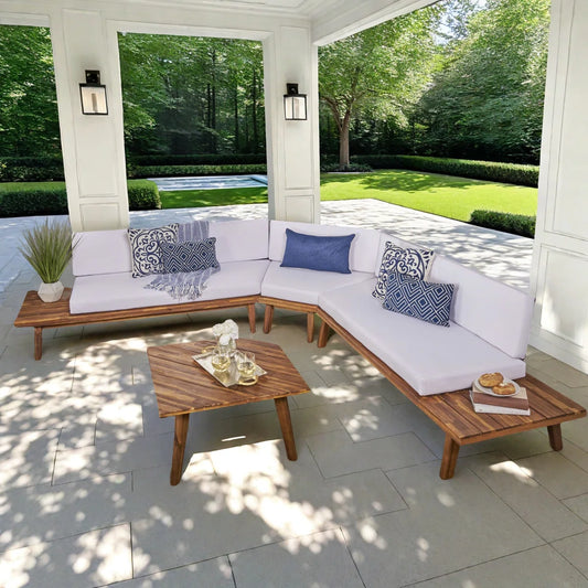 Outdoor patio with wooden sectional sofa, coffee table, and decorative pillows.