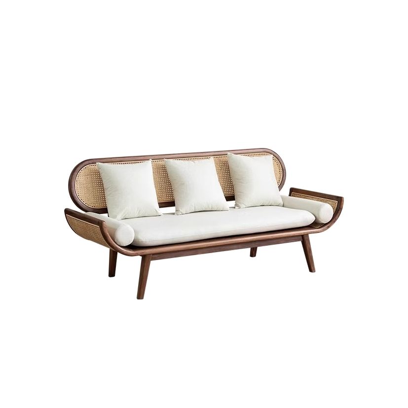 Wicker sofa with white cushions on a white background
