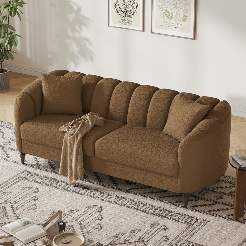 Brown sectional sofa in a living room with a rug and small table.