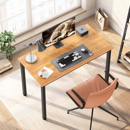 Wooden desk with office equipment in a bright room.