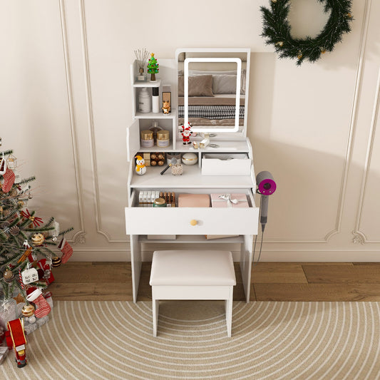 White vanity table with mirror, stool, and decorative items in a room with a Christmas tree and wreath.