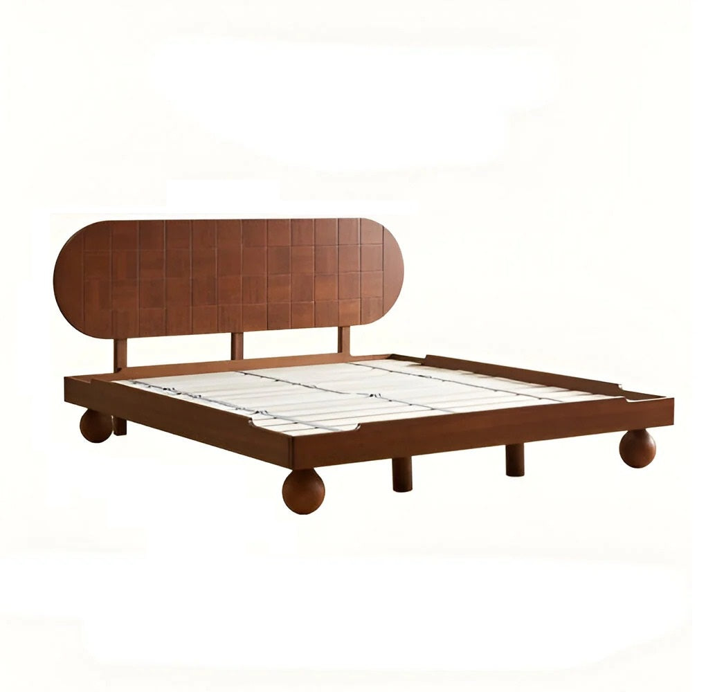 Wooden bed frame with a quilt on a white background