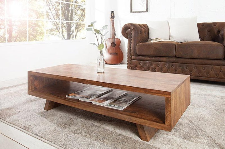 Wooden coffee table with magazines in a living room setting