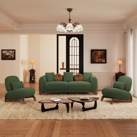 Modern living room with green sofa and chairs, wooden coffee tables, and decorative elements.