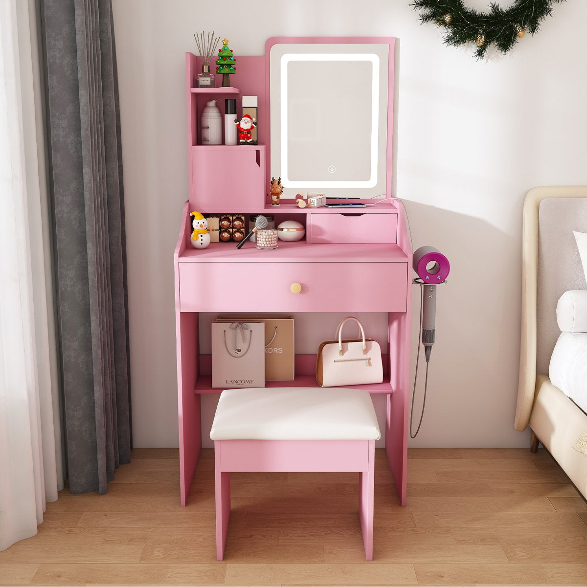 Pink vanity table with mirror and stool in a bedroom setting