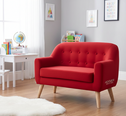 Red children's sofa in a room with educational items and a white table.