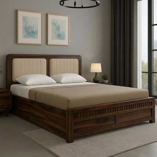 Wooden bed in a bedroom with framed artwork on the wall and a lamp.