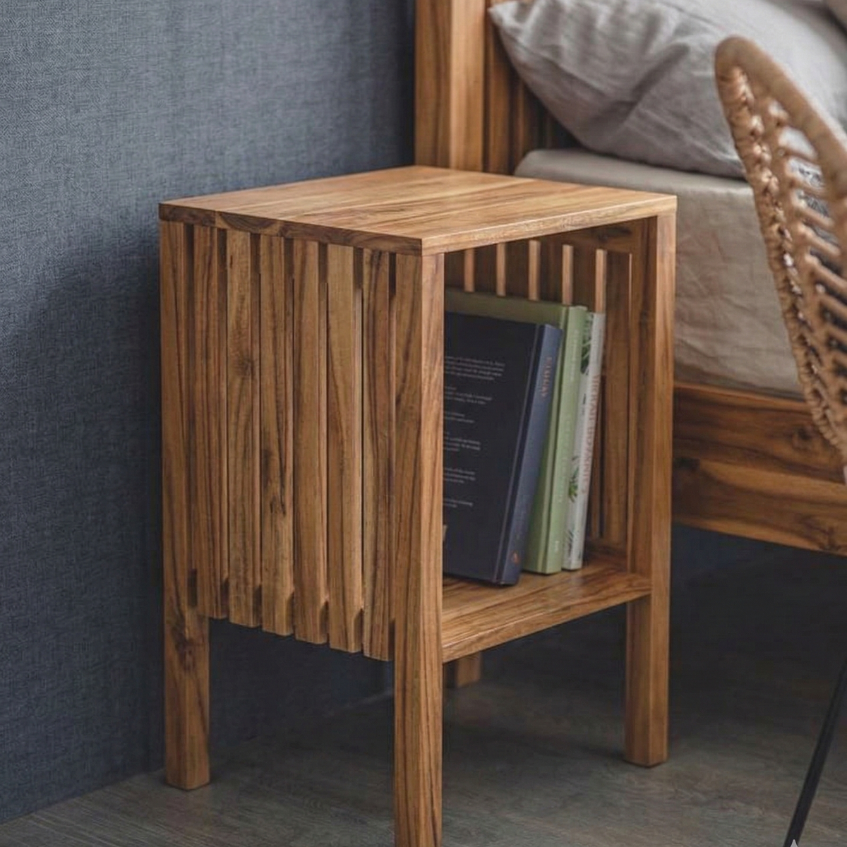 Wooden side table with books against a gray wall