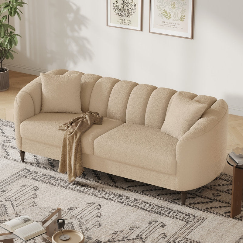 Beige sofa in a living room with a patterned rug and decor elements.