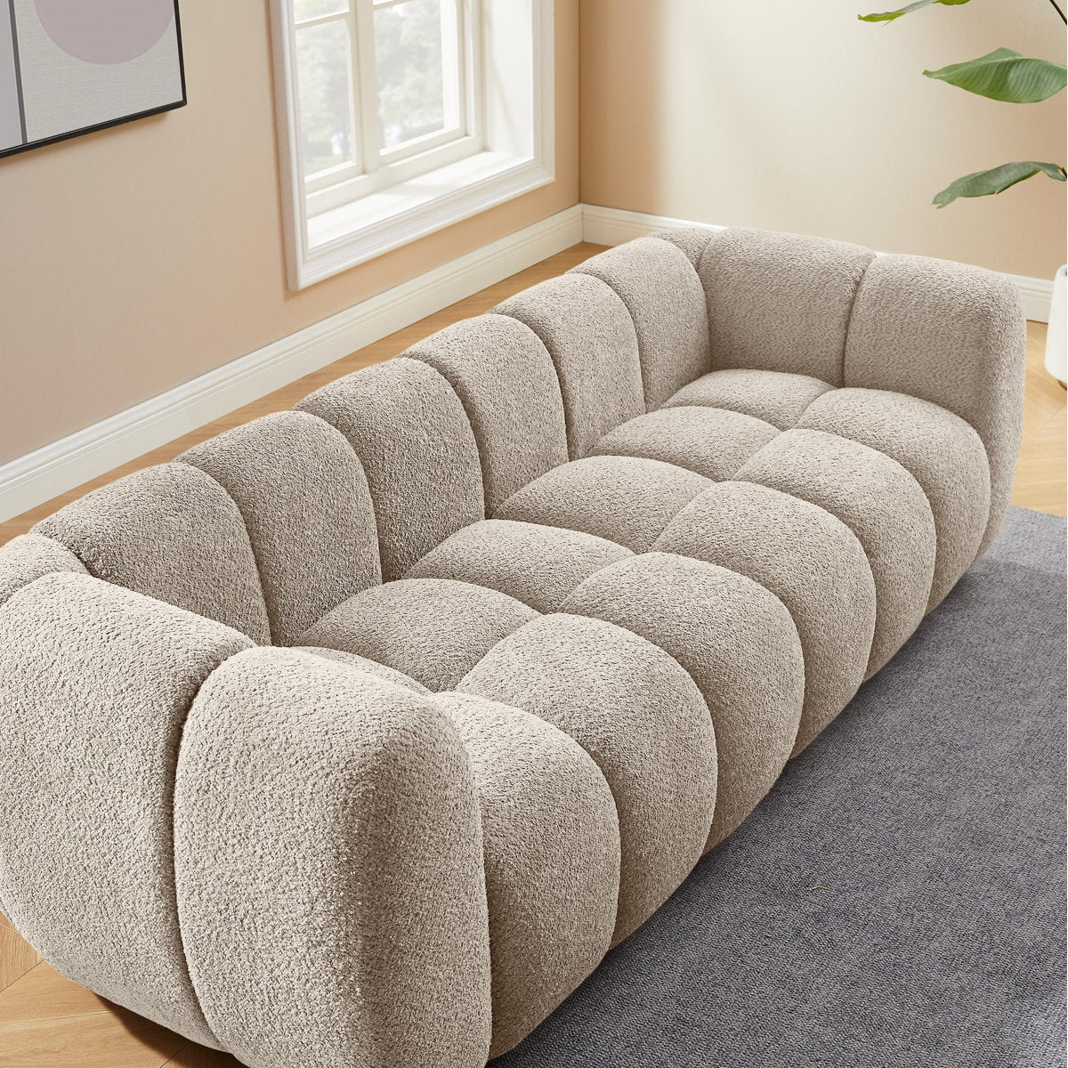 Beige textured sofa in a room with a window and plant