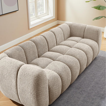 Beige textured sofa in a room with a window and plant