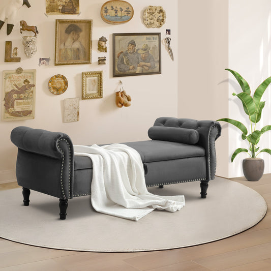 Gray upholstered bench with a white blanket in a room with decorative wall art and a plant.