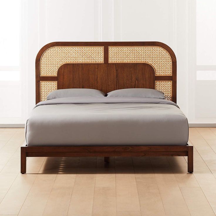 Wooden bed with wicker headboard in a minimalistic room