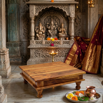 Wooden table in front of an ornate temple altar with statues and offerings.
