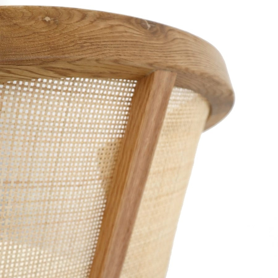 Close-up of a wooden chair with woven seat and backrest on a white background