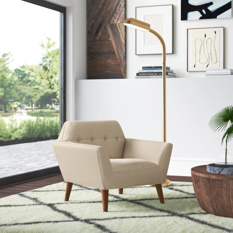 Beige armchair in a modern living room with a lamp and window view.