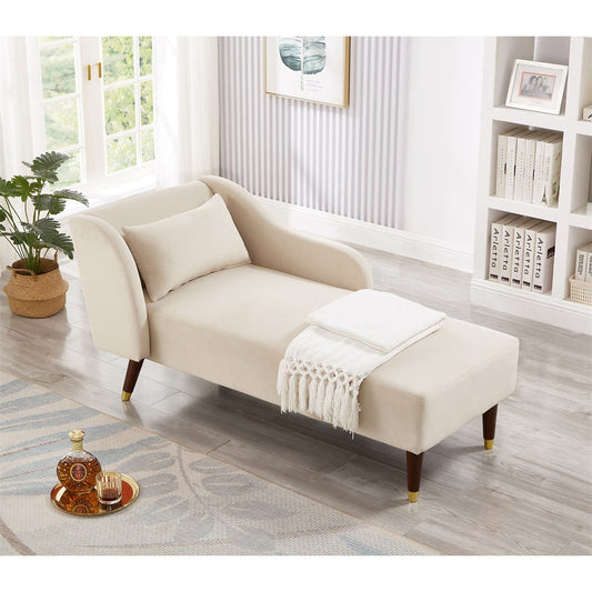 Beige chaise lounge in a room with a bookshelf and plant