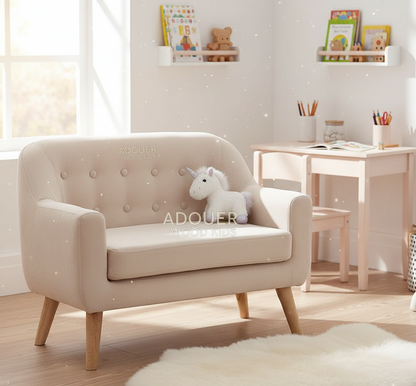 Beige children's armchair with a unicorn toy in a room with a desk and shelves.