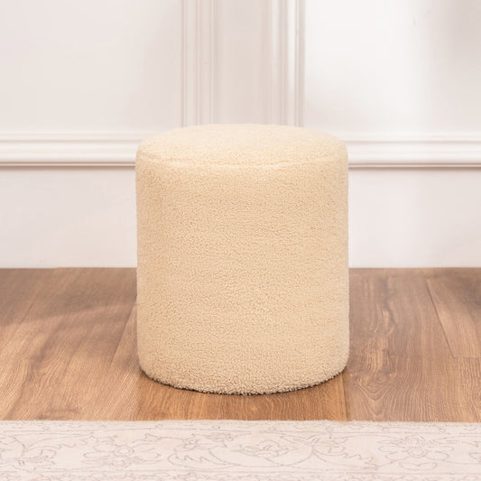 Beige textured ottoman on a wooden floor with a neutral wall background