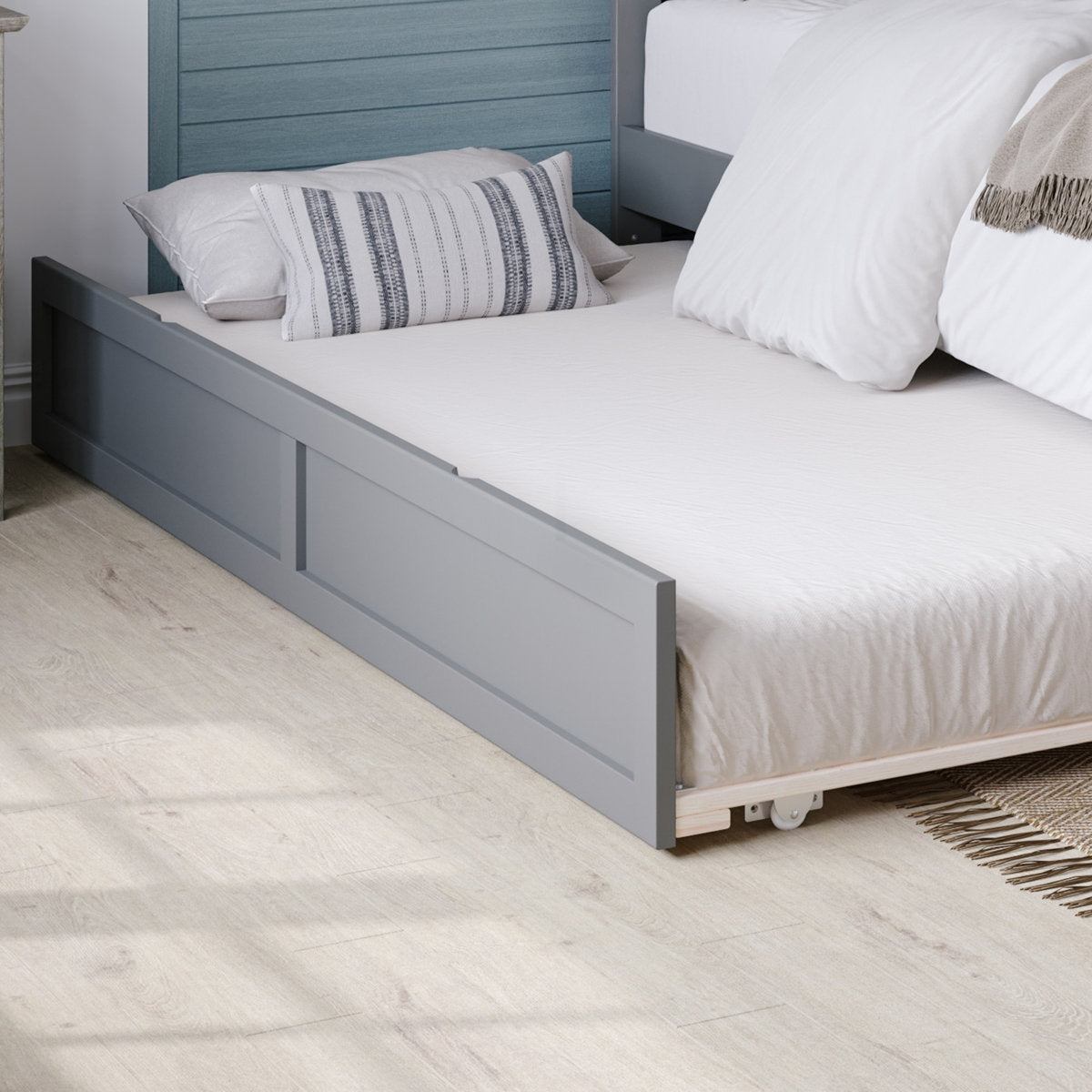 Gray bed frame with white bedding and pillows in a bedroom setting.