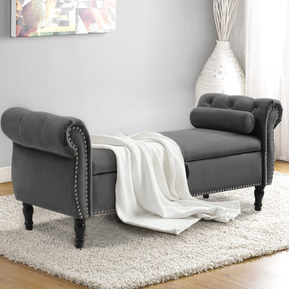 Gray upholstered bench with a white blanket draped over it in a room setting.