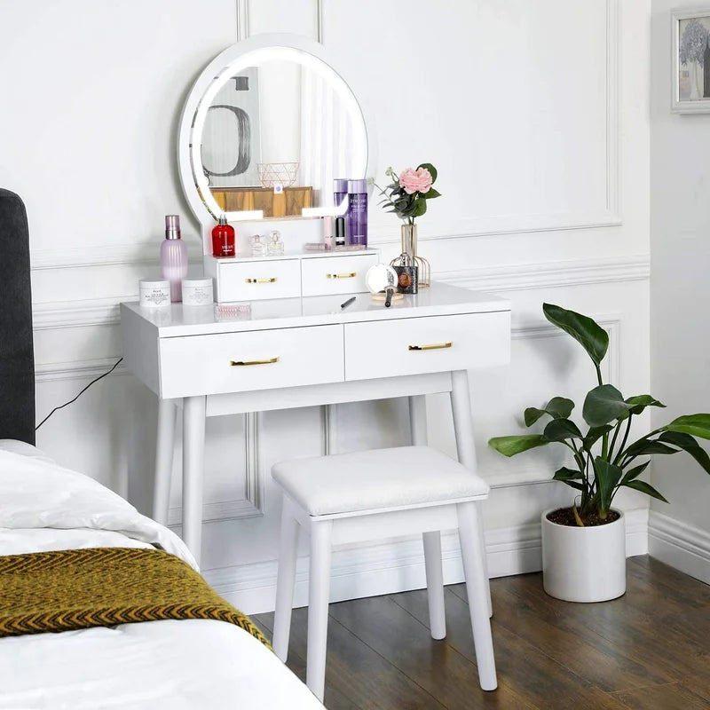 Modern white vanity dressing table with LED mirror and gold handles, featuring four drawers and a stool in a bedroom setting.
