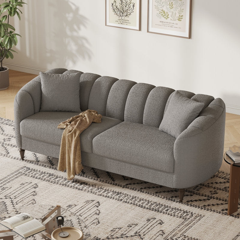 Gray sofa in a living room with a patterned rug and decor elements.