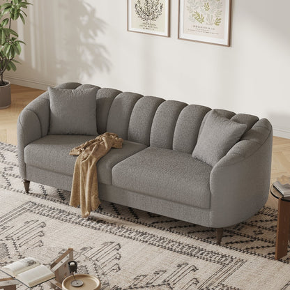 Gray sofa in a living room with a patterned rug and decor elements.