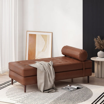 Brown leather sofa in a modern living room with a rug and wall art.