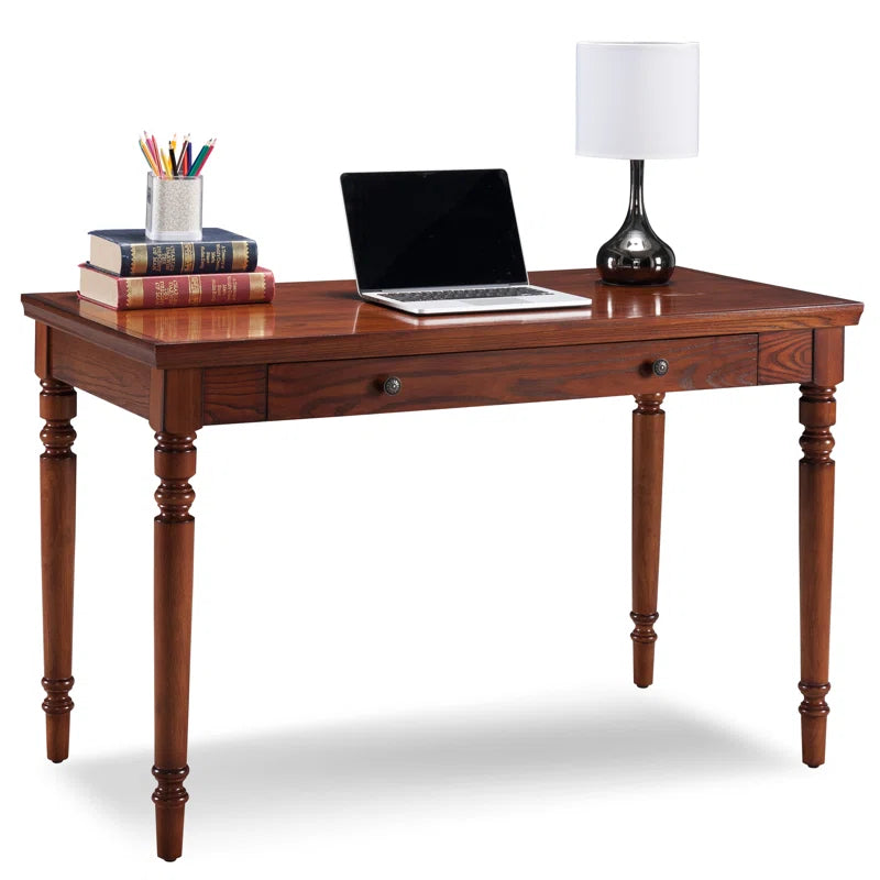 Wooden desk with laptop and lamp on a white background