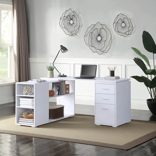 A white L-shaped wooden office desk with storage shelves and drawers, displayed in an office setting with decorative items and a laptop on top.