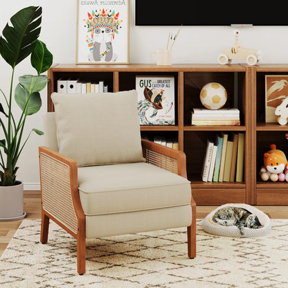 Beige armchair in a living room with a bookshelf and decorative items.