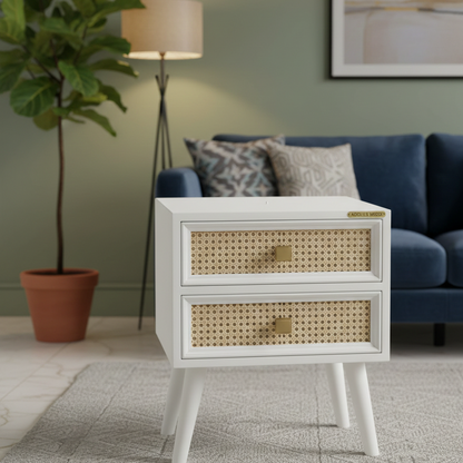 White nightstand with wicker drawers in a living room setting