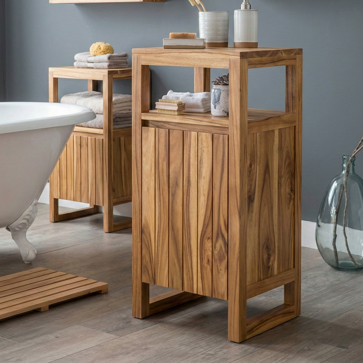 Wooden bathroom cabinet with towels and decor items in a bathroom setting