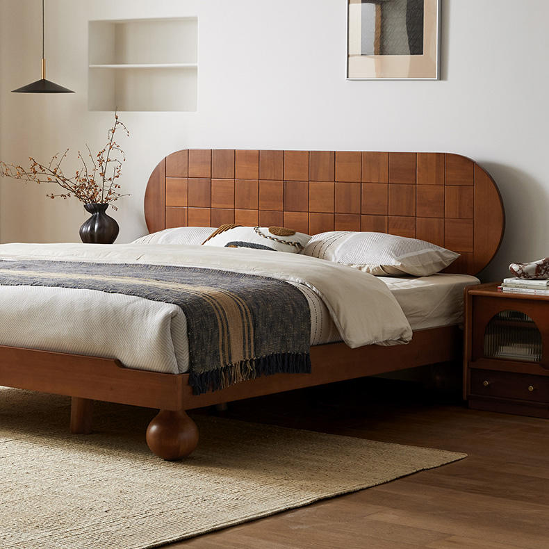 Wooden bed with spherical leg in a bedroom setting