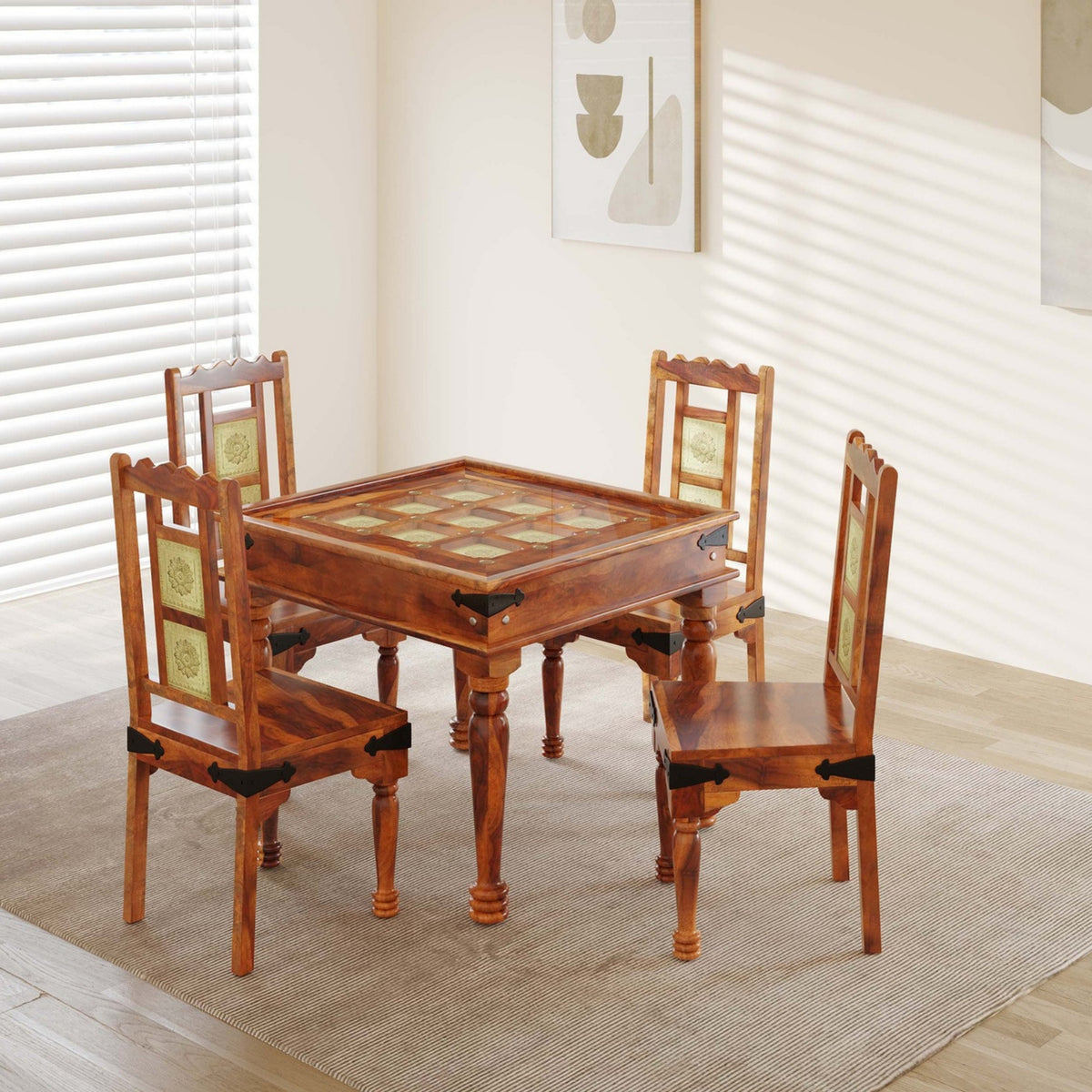 Wooden dining table with four chairs in a room with white walls and blinds.