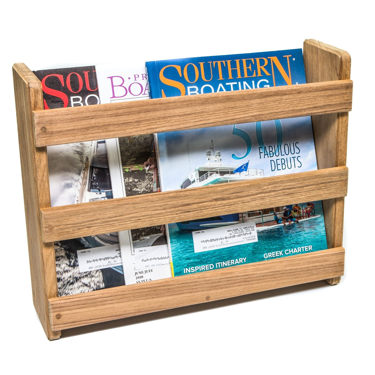 Wooden magazine rack with various magazines on a white background
