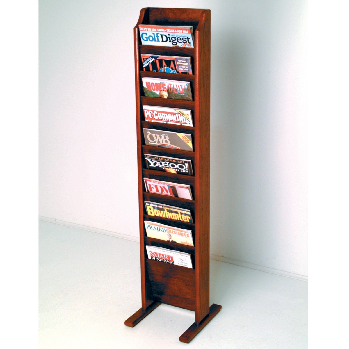 Wooden magazine rack with various magazines displayed on a white background