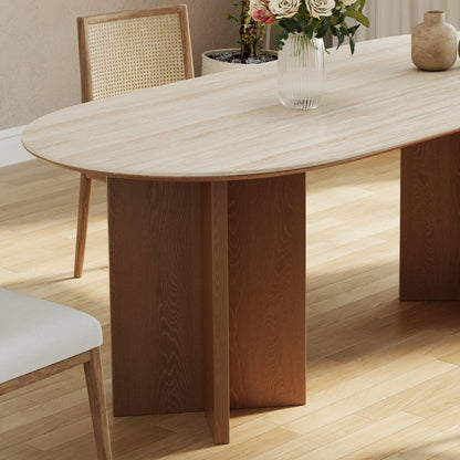 Wooden dining table with chairs and decorative items in a room.