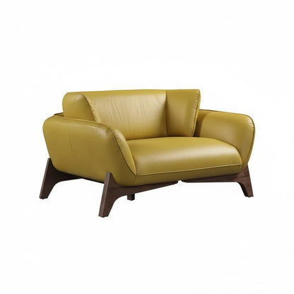 Yellow leather sofa with wooden legs on a white background