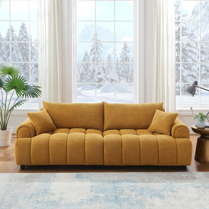 Yellow sofa in a living room with large windows showing a snowy outdoor view.