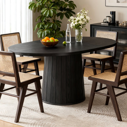 Dining room with a black round table, chairs, and decorative items.