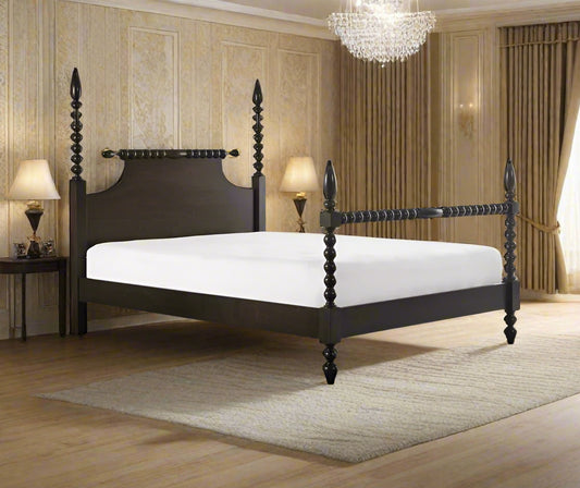 A solid sheesham wood poster bed with a walnut finish, featuring a high headboard and footboard, set in a bedroom environment.